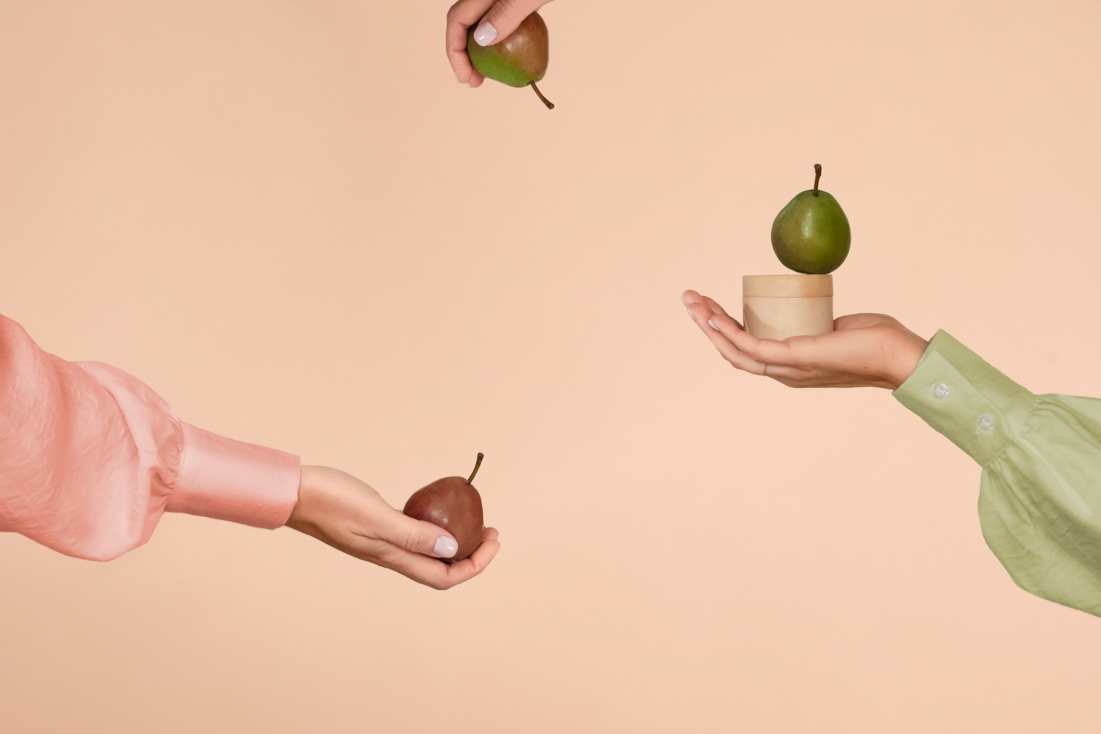 Product photo with a woman model presenting pears and a jar of cosmetic cream styled by Jenni Joanna Visuals.